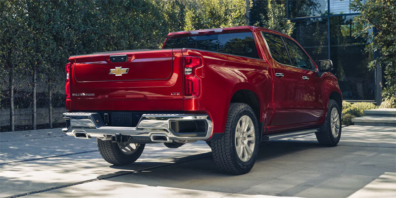 Red Chevrolet Silverado 1500 pickup truck parked outdoors.
