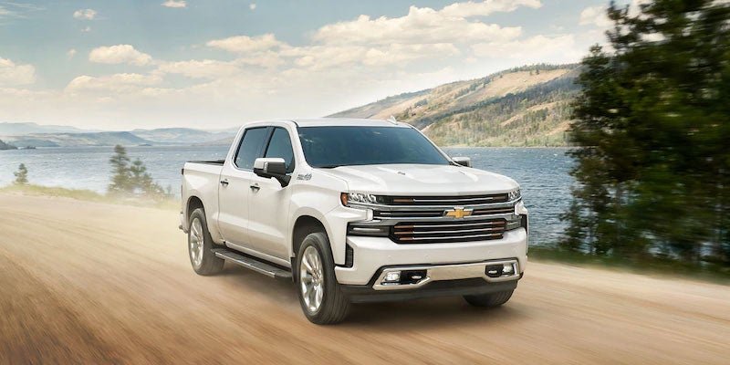Chevrolet Silverado 1500 driving on offroad side of lake
