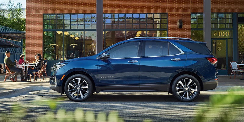 2022 Chevrolet Equinox parked on a street, with shops surroundings.