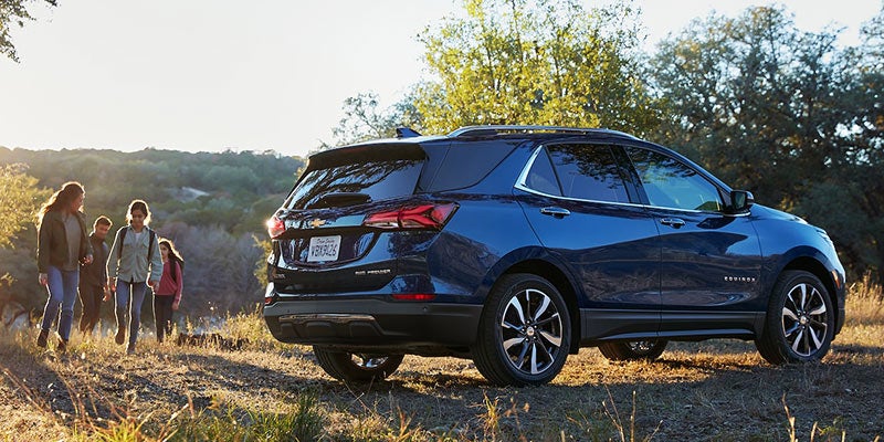2022 Chevrolet Equinox parked in a forest, surrounded by trees and nature.
