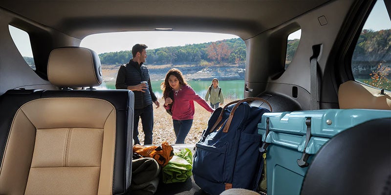 Chevrolet Equinox with a spacious back trunk filled with luggage.